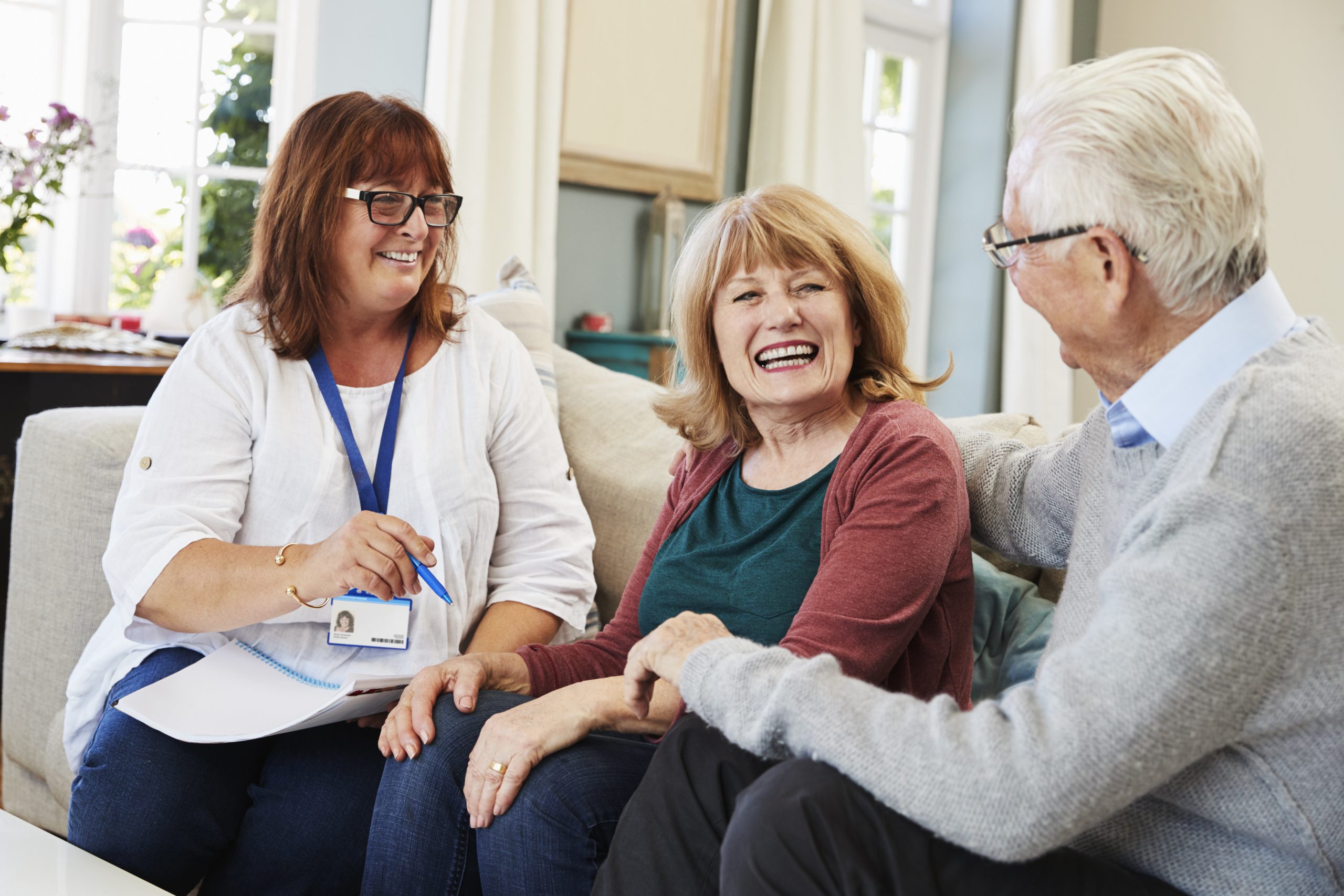 A woman talking to an elderly couple