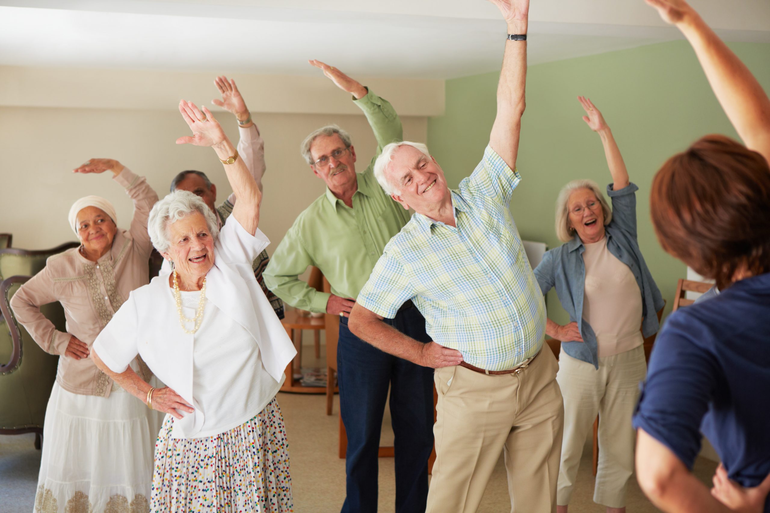 A group of elderly people doing exercises