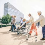 A group of elderly people walking outdoors
