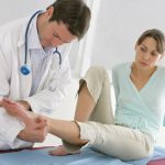 A Podiatrist assisting a patient