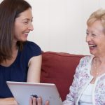 Speech Pathologist, Bernadette Dutton, laughing with an elderly woman