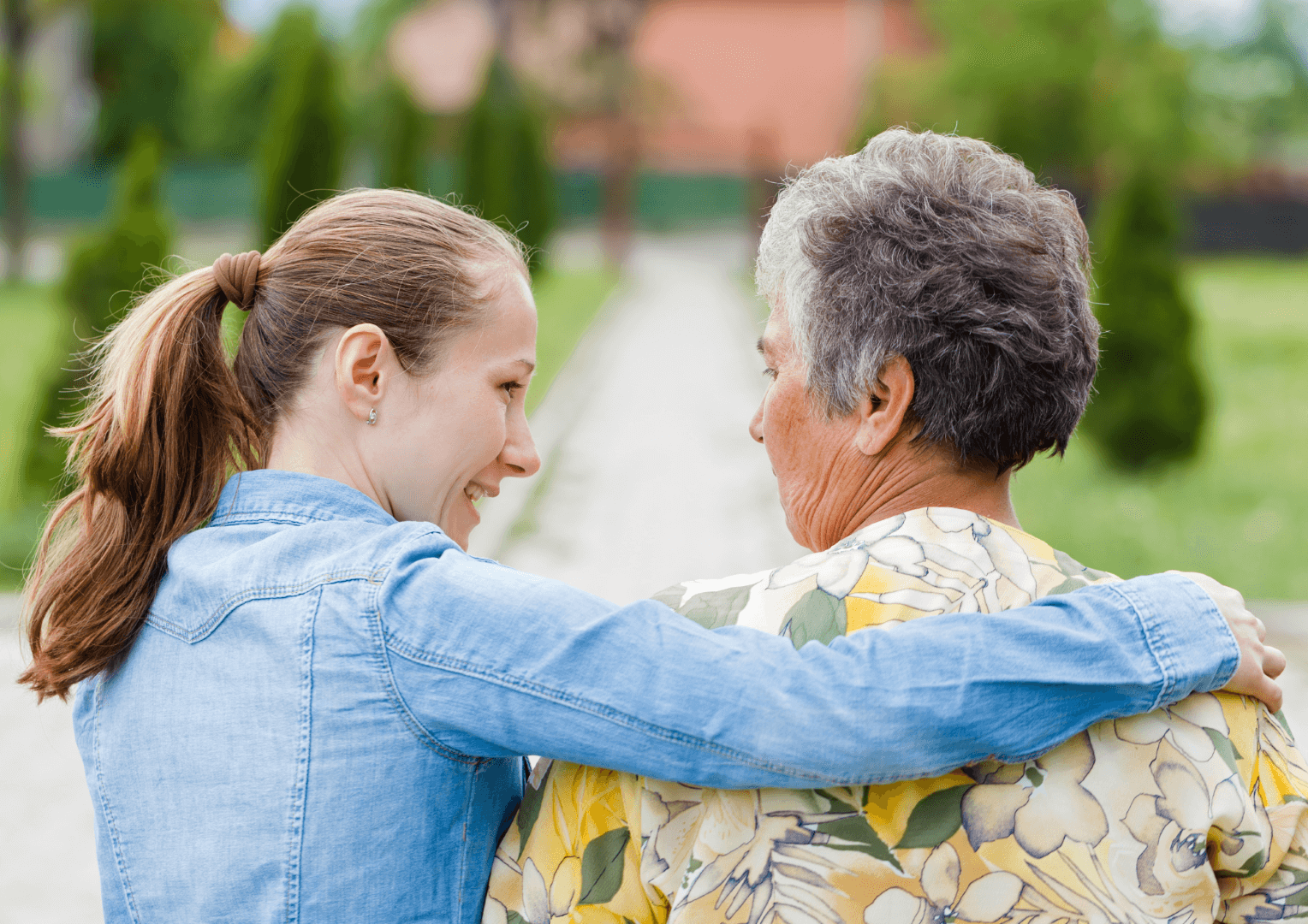 A woman with her arm around an elderly woman