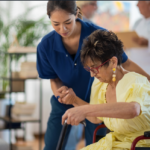 OT helping elder lady stand up from wheelchair